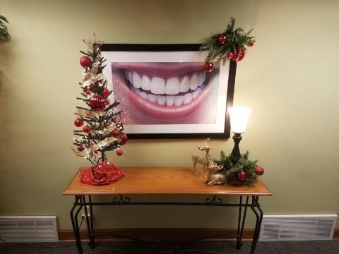 Frame of smiling face surrounded by Xmas trees